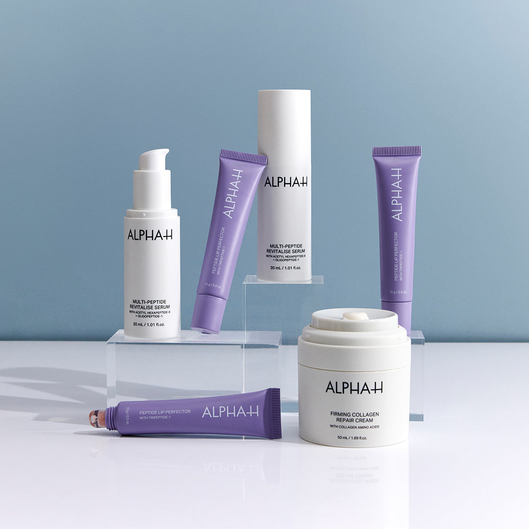 Collection of Alpha-H skincare products, including peptide and collagen products, on a light blue background