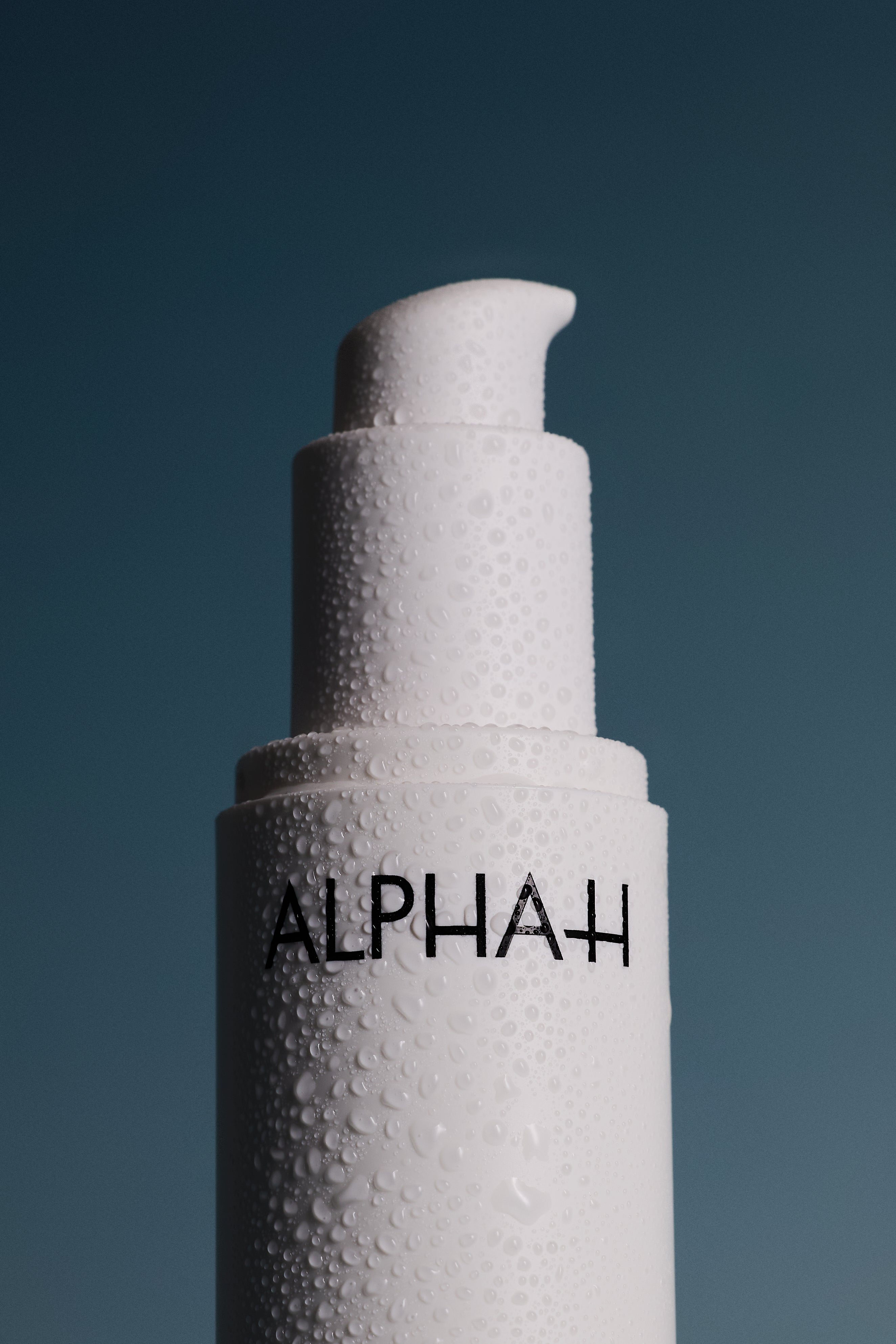 Alpha-H skincare bottle of Multi-Peptide Revitalise Serum on dark blue background